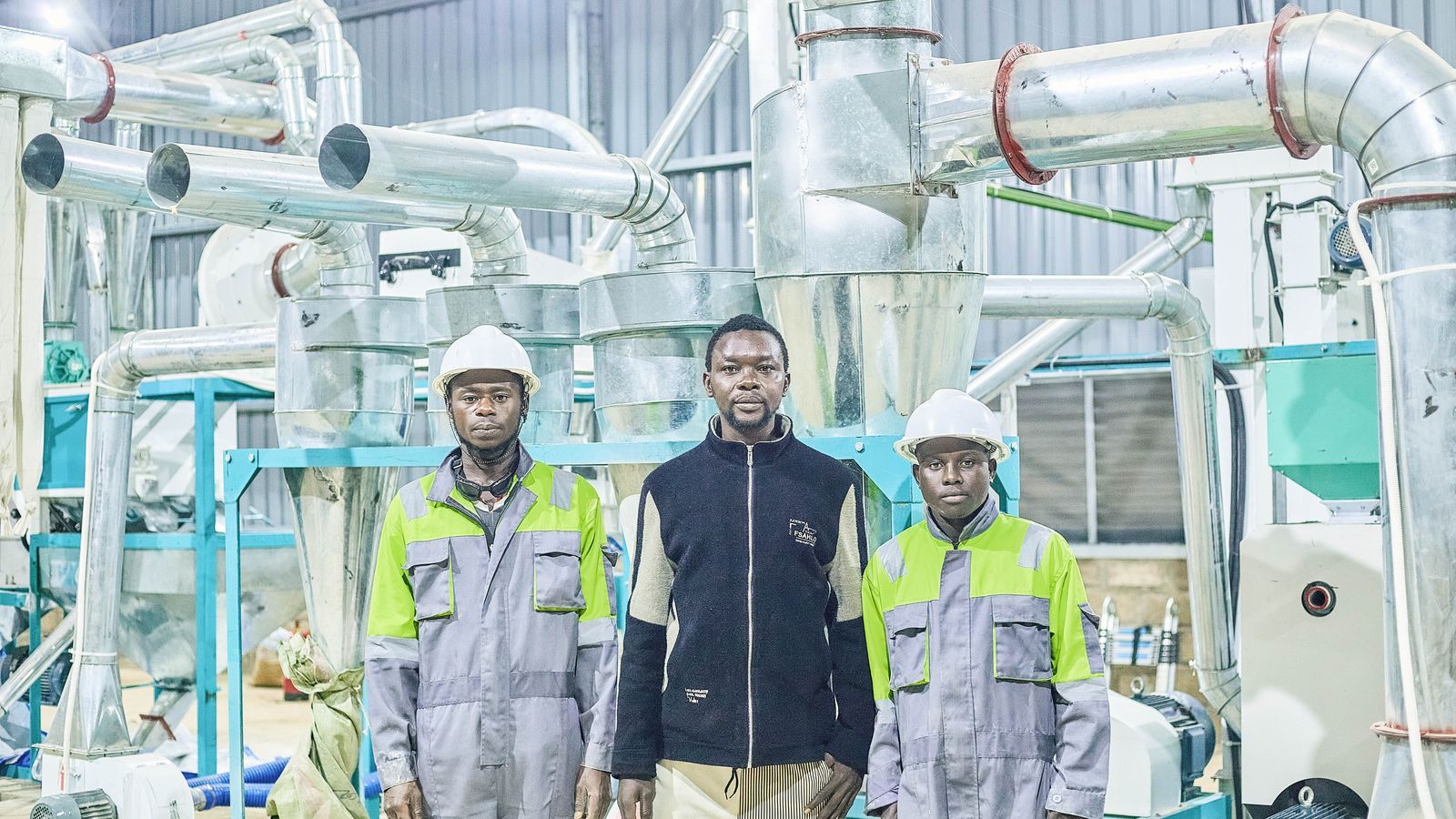 CICOAGRI technicians in front of the flour mill's milling line